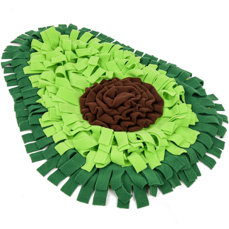 The green avocado-shaped snuffle mat seen from above: two-tone green fleece strips around a brown fleece rosette, on a white background.