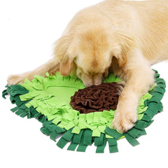 A golden retriever standing over the green avocado snuffle mat with its nose in the brown centre rosette.