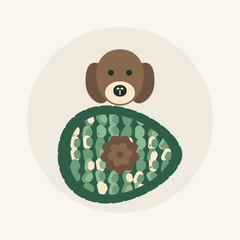 A dog above the avocado-shaped snuffle mat, nose lowered towards the fleece strips